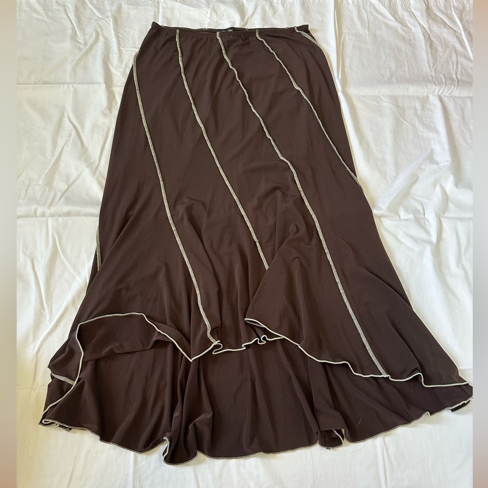 Long brown skirt, longer in the back, shorter in front